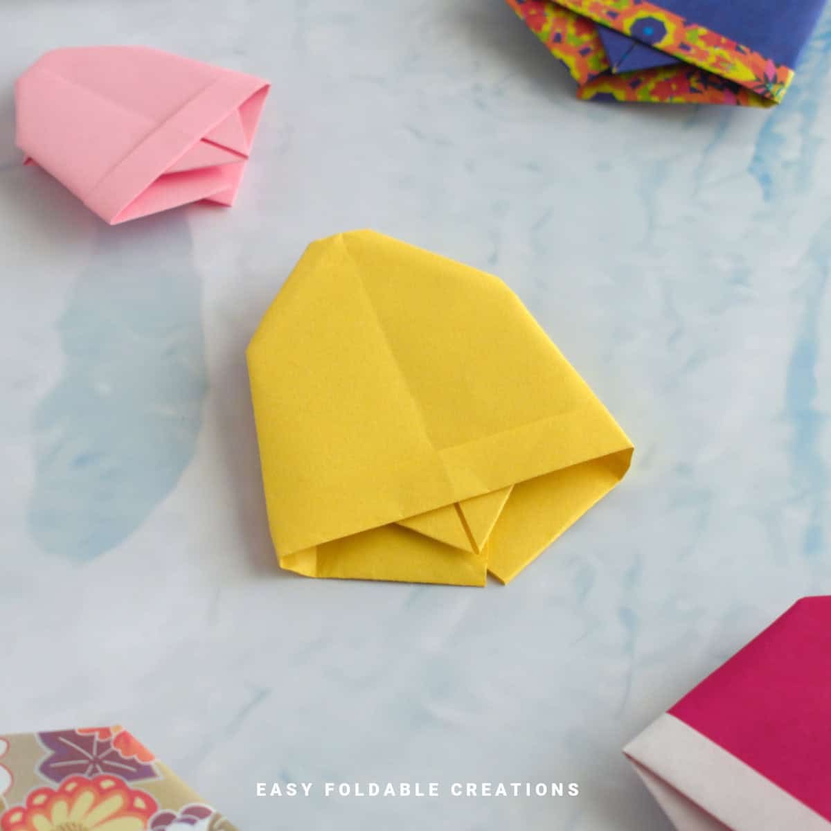 Close up image of a yellow origami bell.