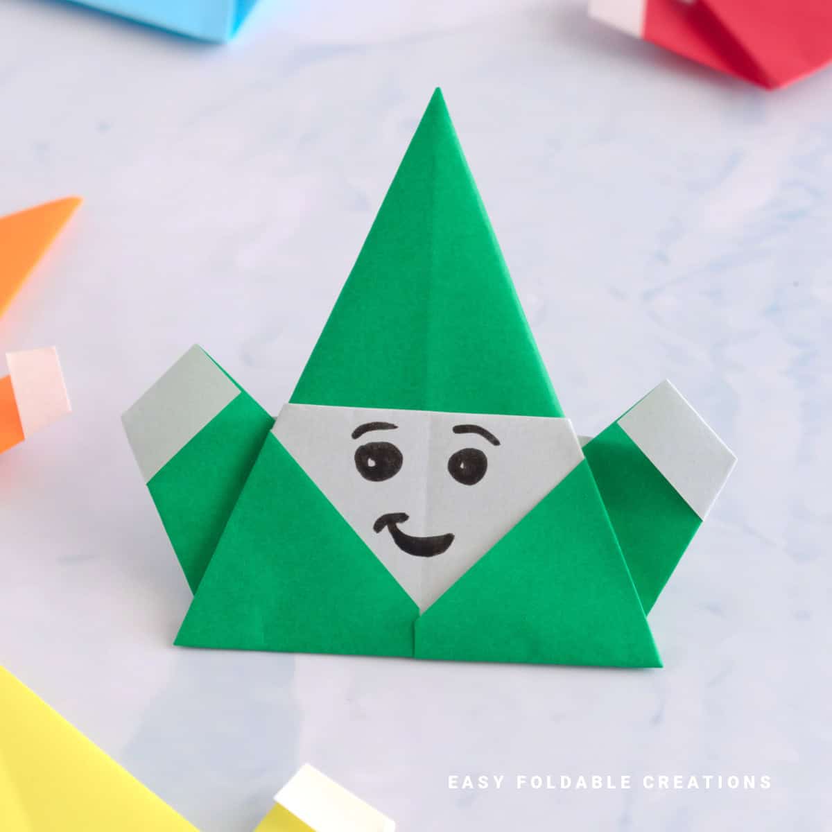 Close up image of a green origami Santa.