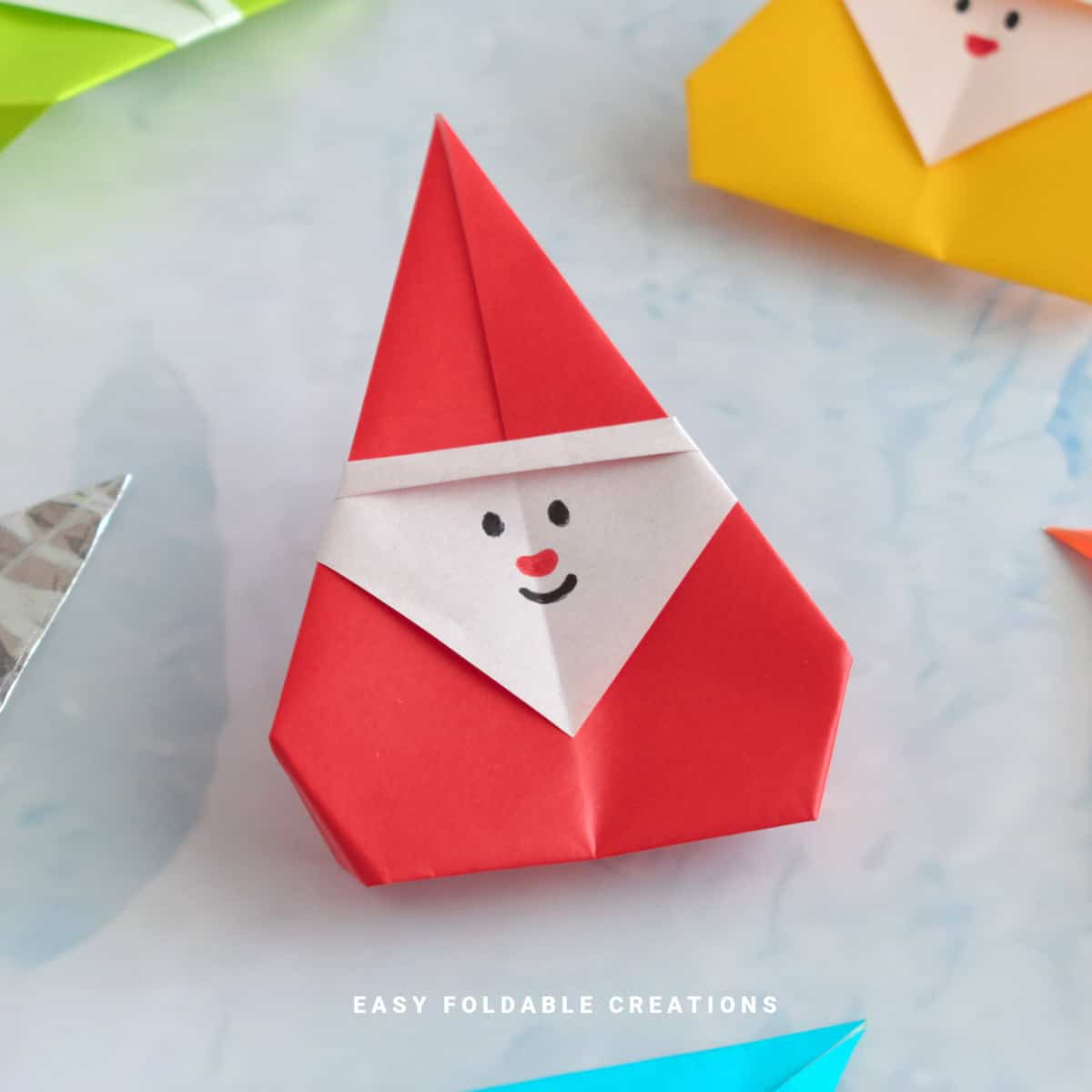 Close up image of a red origami Santa.