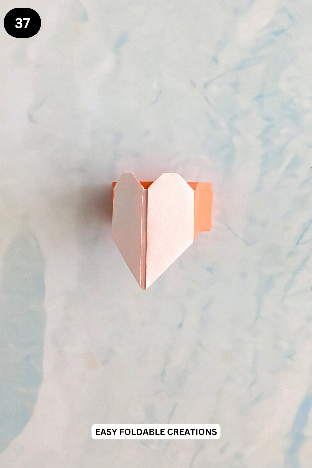 Step 37 for folding an origami heart ring.