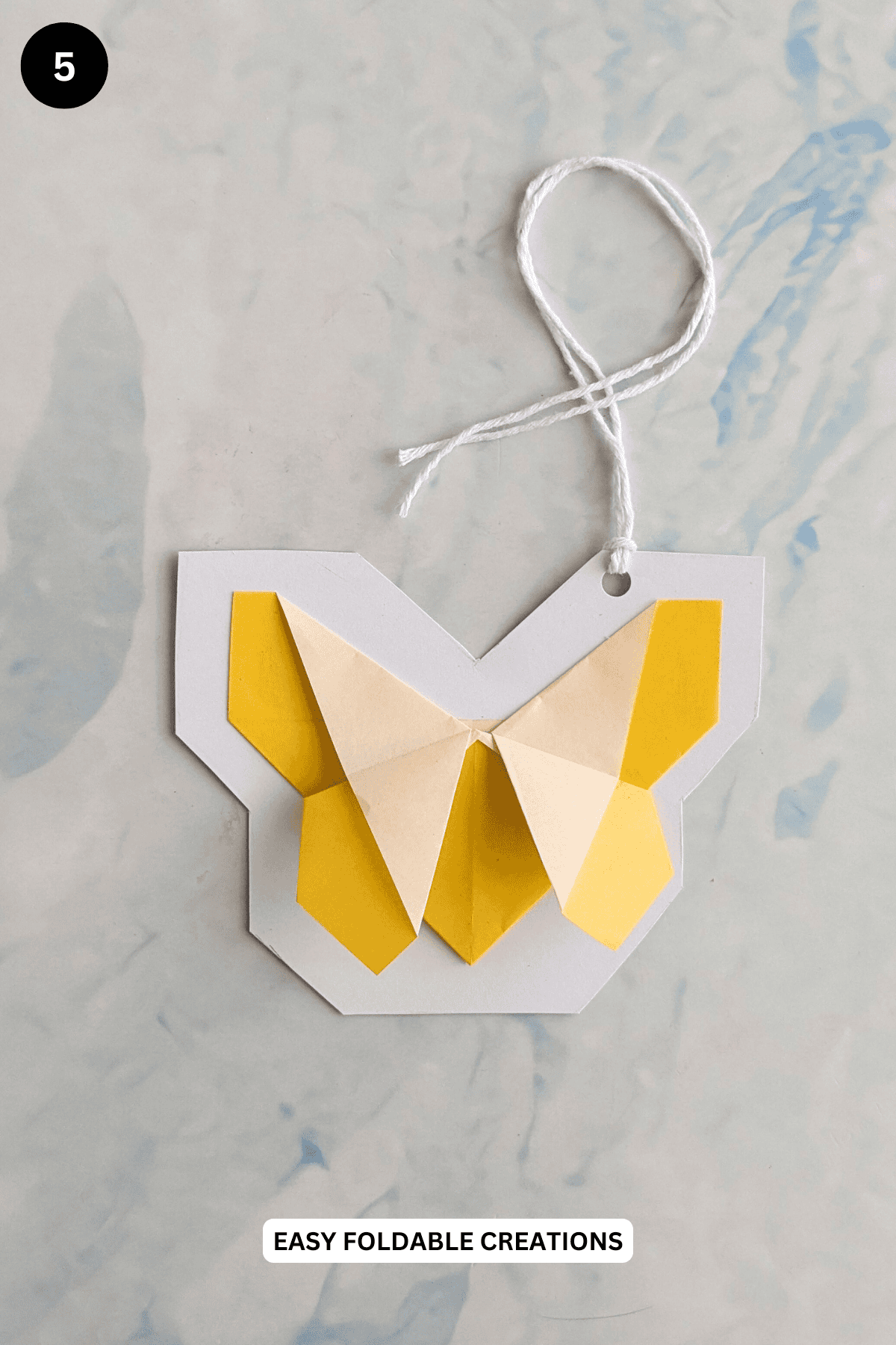 Step 5 for making a butterfly gift tag.