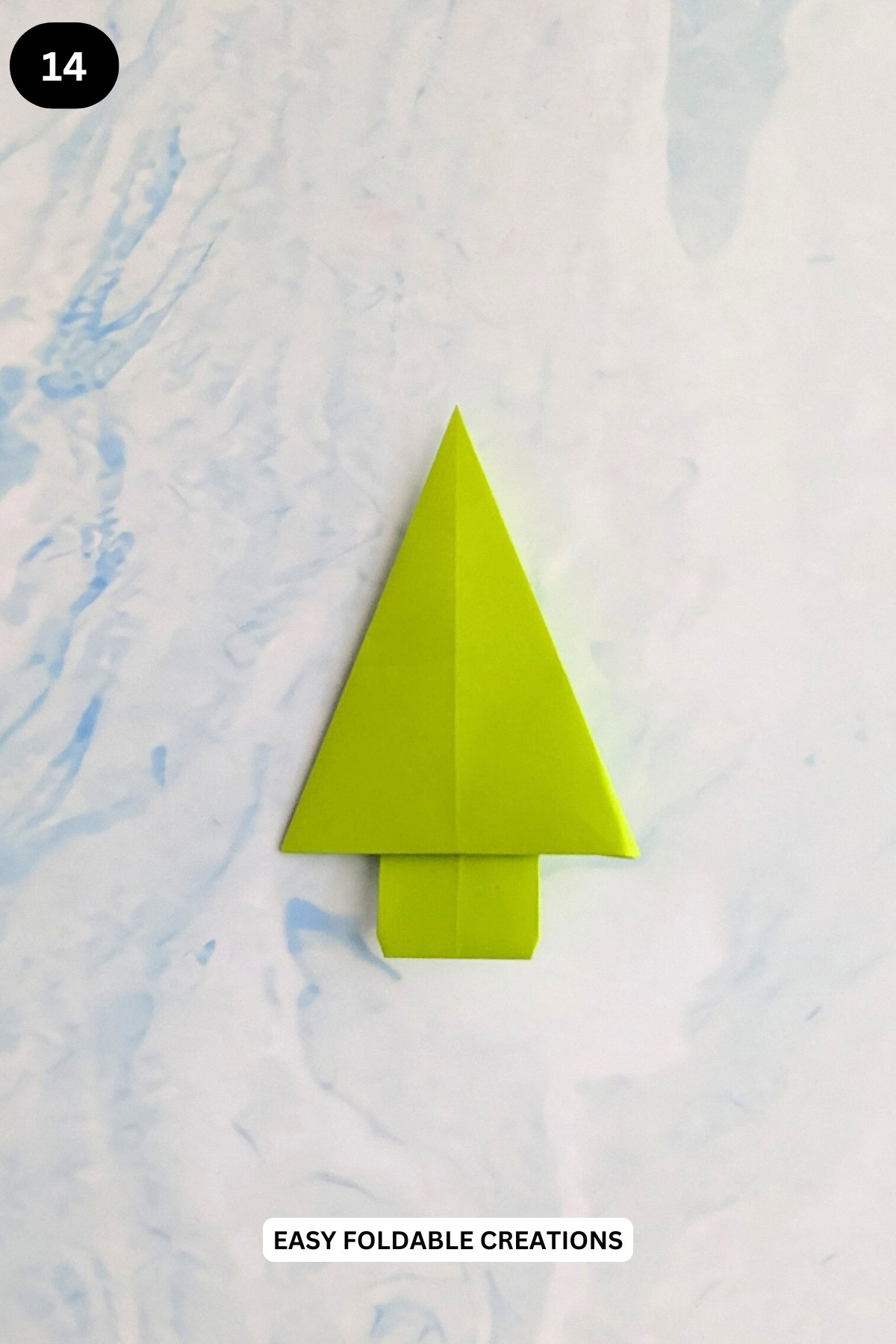 Step 14 for folding a 2D origami Christmas tree.