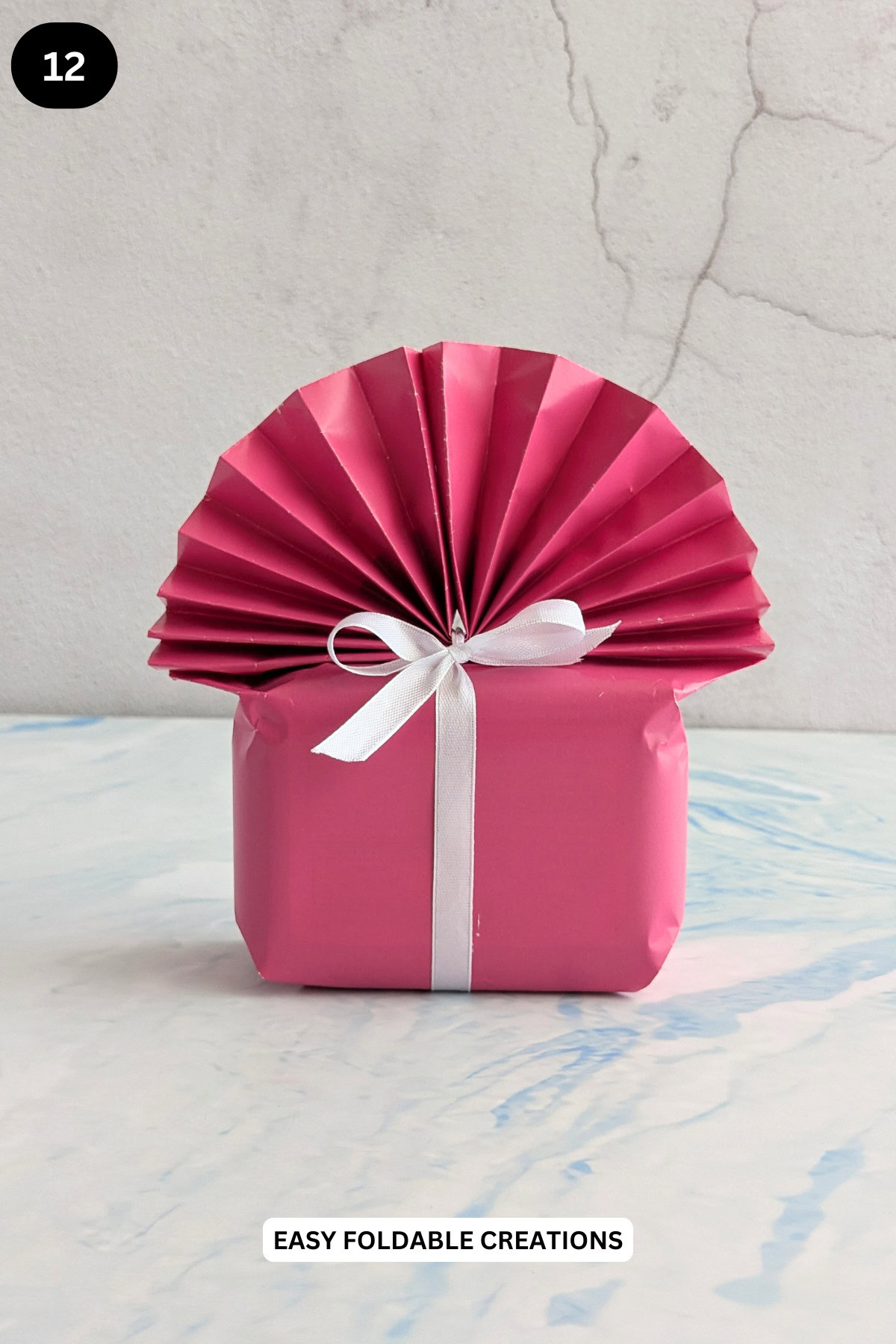 Step 12 for wrapping a gift with a fan.