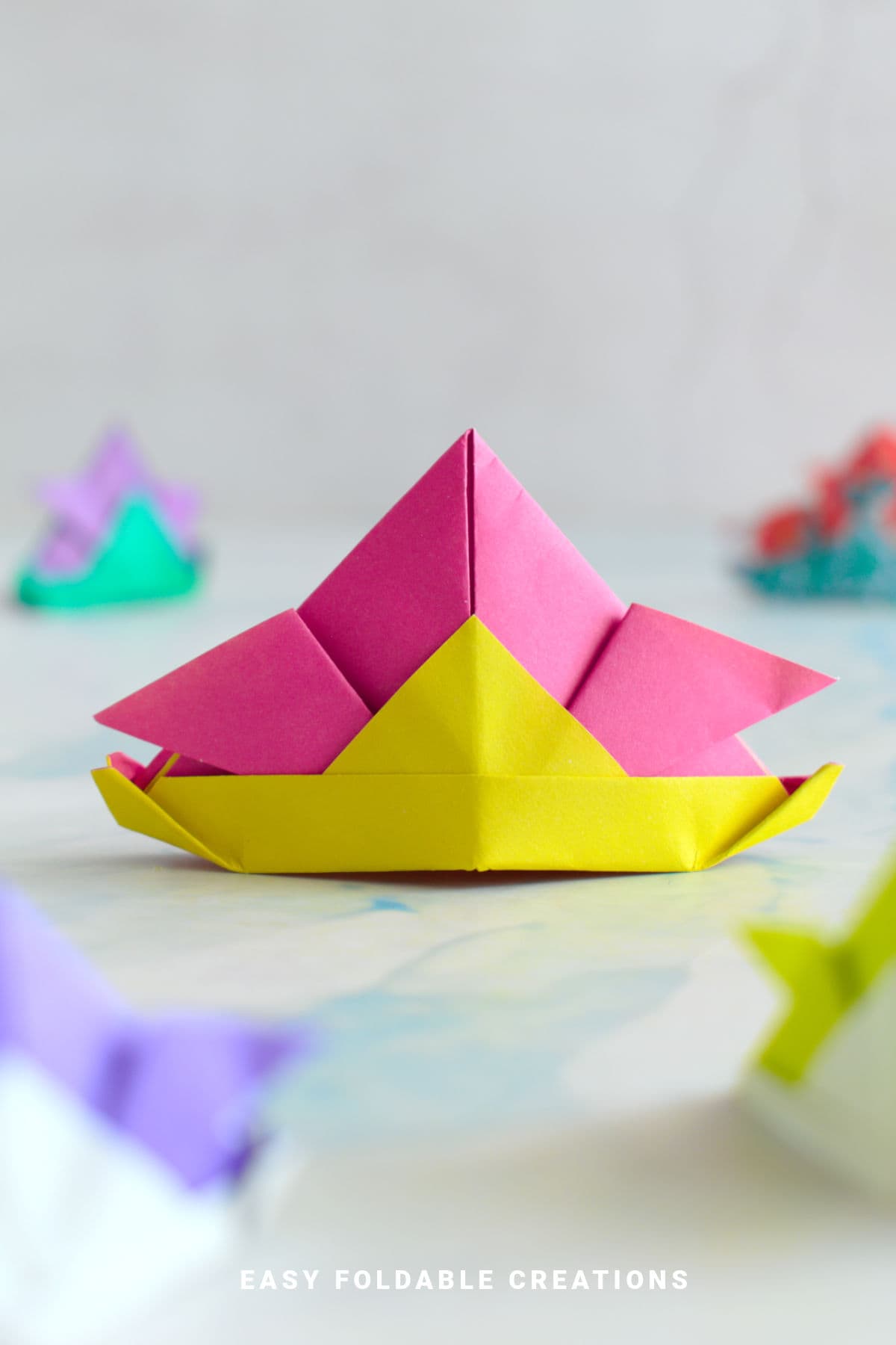 Pink and yellow origami samurai hat.
