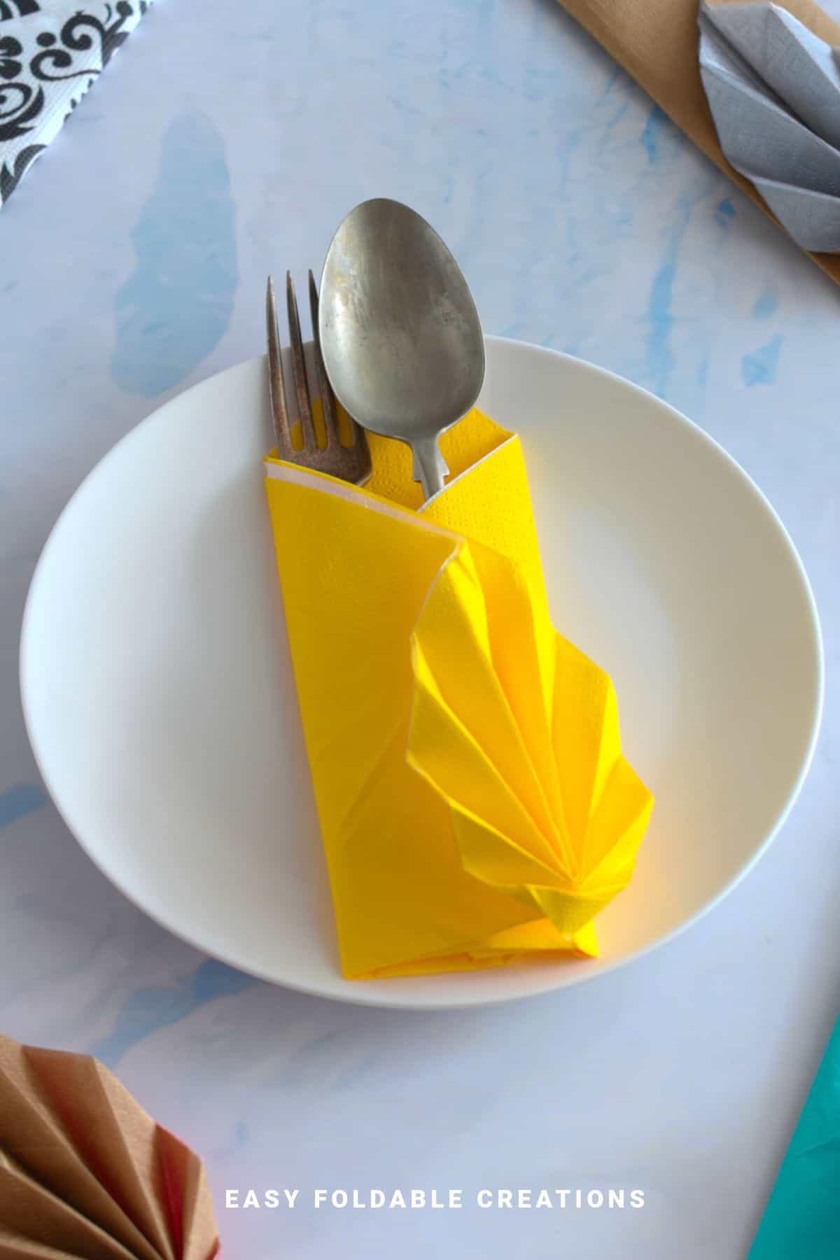 Yellow napkin fold.