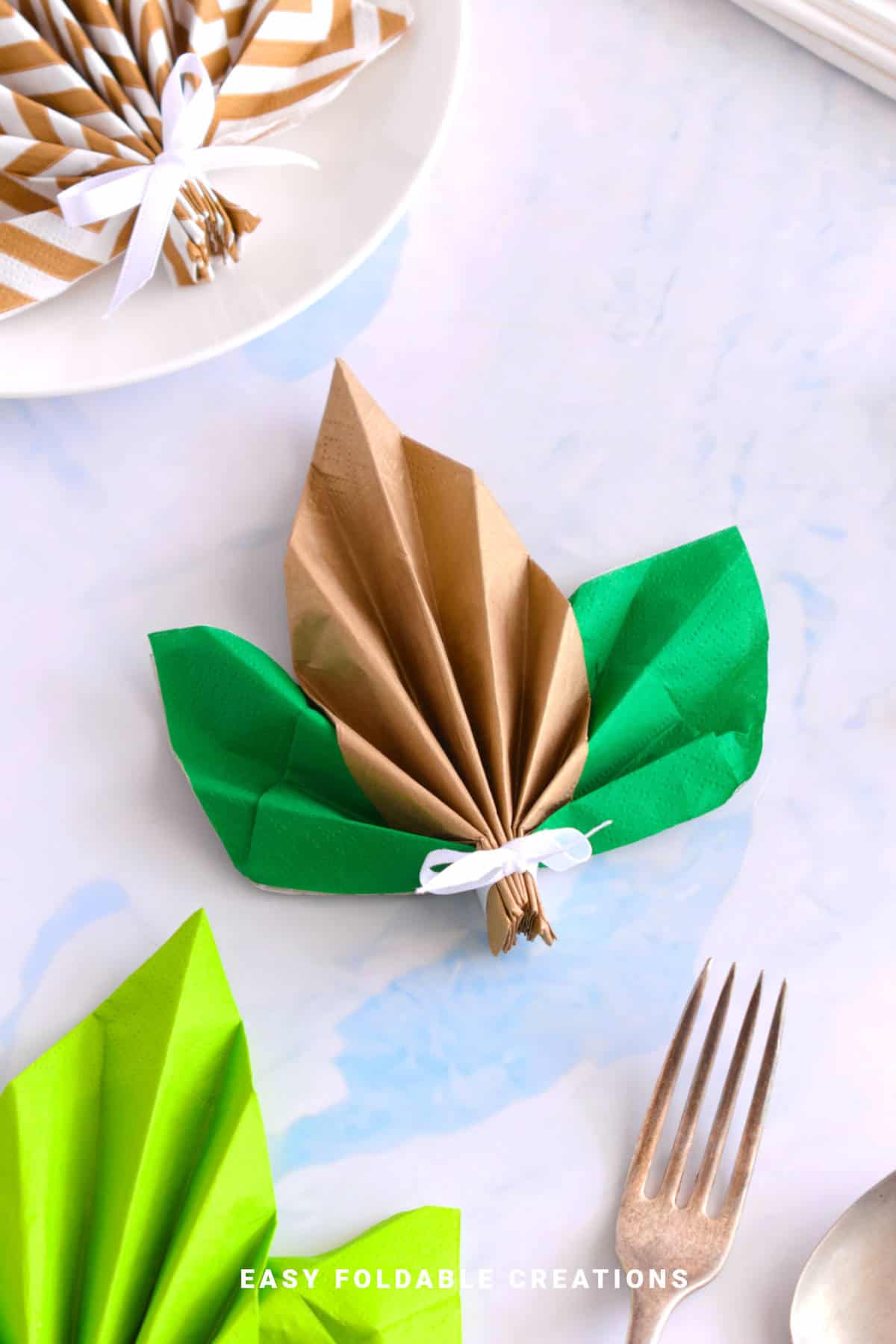 Folded napkin in the shape of a leaf.
