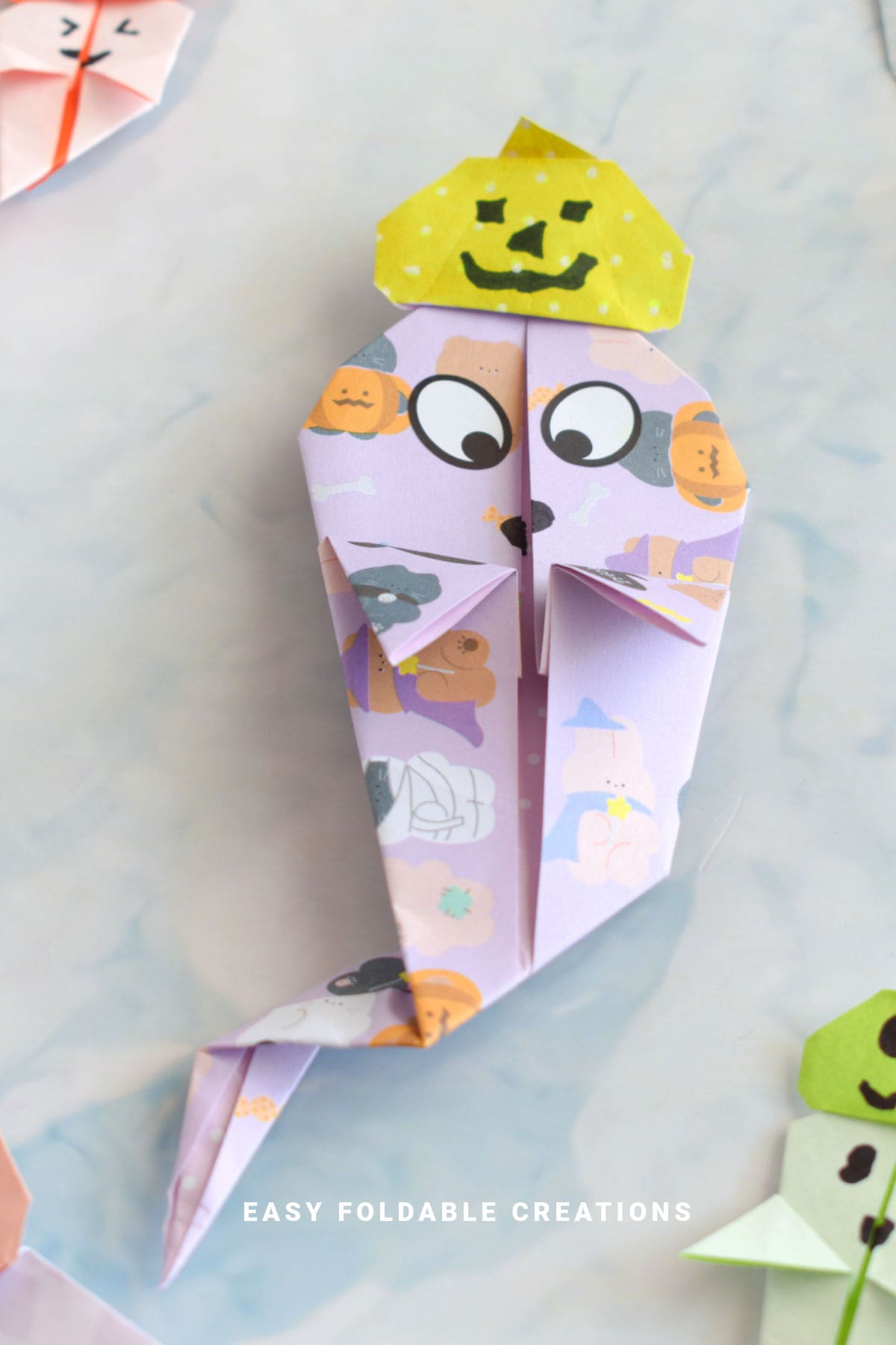 Origami ghost with pumpkin hat.