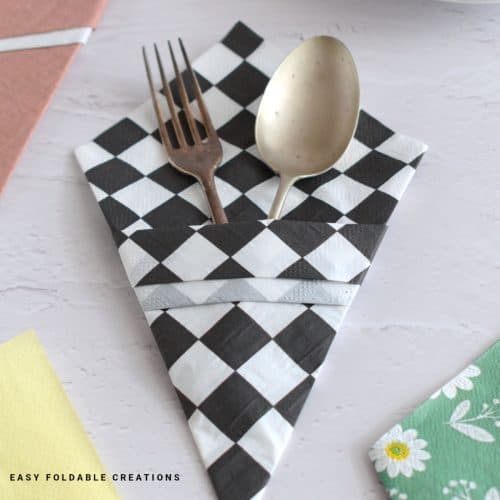 Close up image of a checkered paper napkin fold.