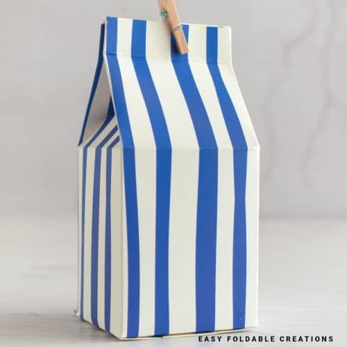 Close up image of a blue and white milk carton gift box.