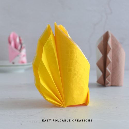 Yellow napkin fold.