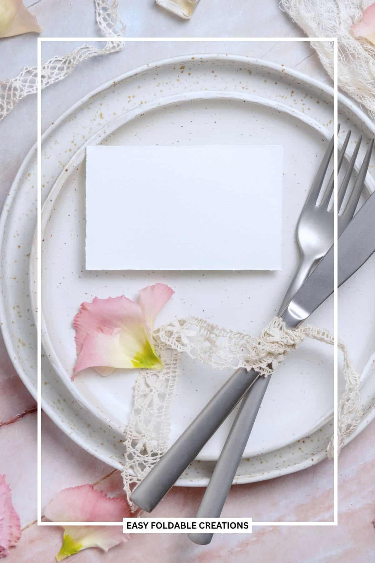 Place card on a stack of plates with cutlery.